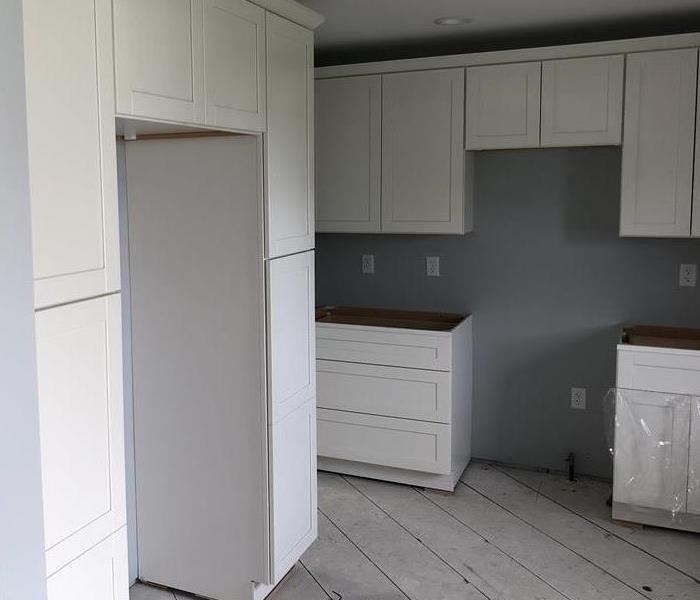 This image shows the kitchen of the same home further into the repair